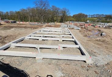Concrete beams lying on the ground at a construction site