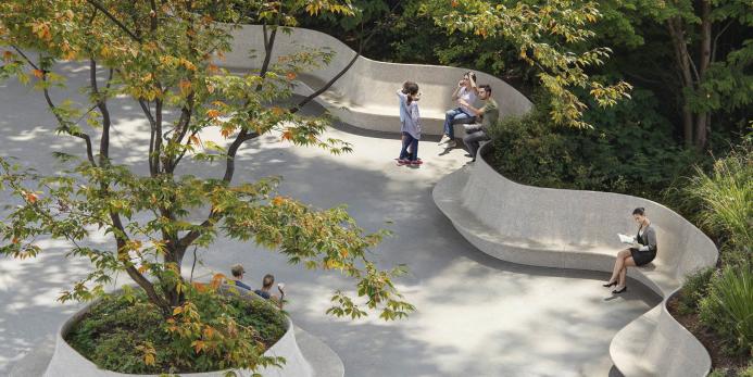 People sitting on crete seats in a park