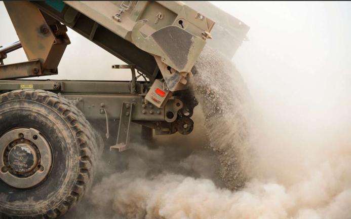 A tipper truck unloading sand