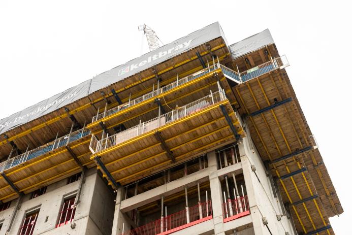 The top of an under construction building surrounded by yellow formwork