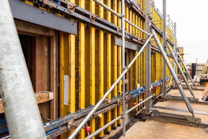 Yellow formwork and steel scaffolding in use to construct a new building