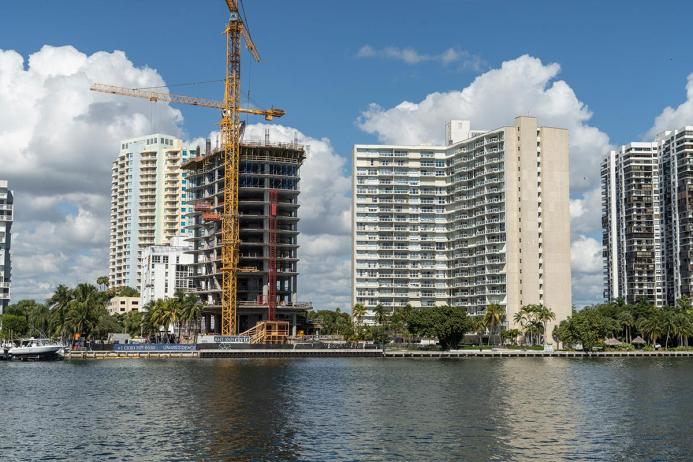 A high rise under construction with yellow formwork 