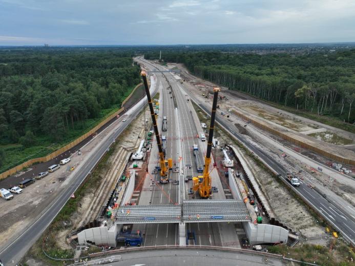 Two yellow cranes construct a new bridge