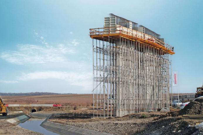 A bridge pier under construction covered in scaffolding