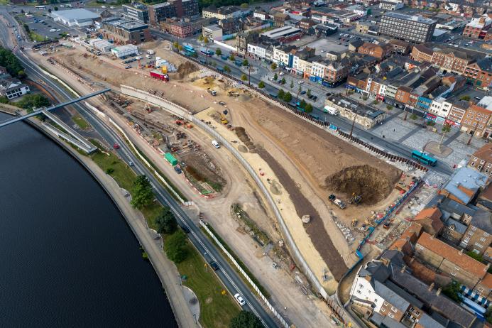 An aerial view of a large construction site next to a river