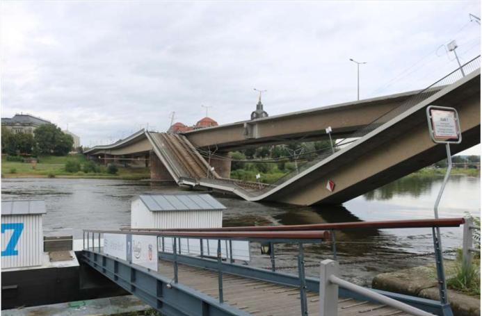 A side view of a collapsed road bridge