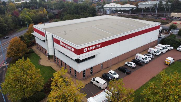 An aerial view of a grey and red factory building