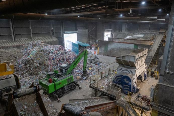 Inside SUEZ's recycling facility at Malpass Farm in Rugby, where Climafuel is produced in order to heat the kiln at Cemex's Rugby cement plant, a green material handler sorts waste