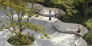People sitting on crete seats in a park