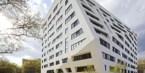 A white, 11 storey angular building