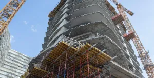 A high rise under construction with yellow formwork 