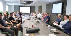 A group of men sitting round a board table