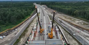 Two yellow cranes construct a new bridge