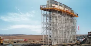 A bridge pier under construction covered in scaffolding