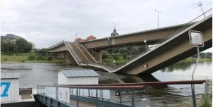 A side view of a collapsed road bridge