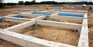 Concrete foundation beams for houses laid out on a construction site