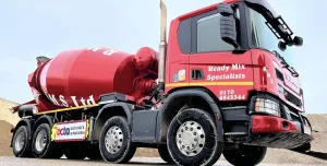 A bright red concrete mixer truck