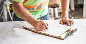 A construction worker looking at plans