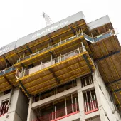 The top of an under construction building surrounded by yellow formwork