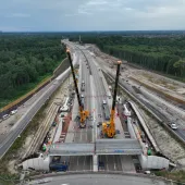 Two yellow cranes construct a new bridge