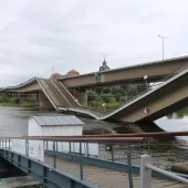 A side view of a collapsed road bridge