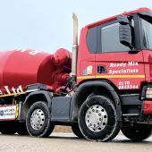 A bright red concrete mixer truck