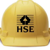 A yellow hard hat with the HSE logo in black on its front