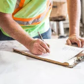 A construction worker looking at plans