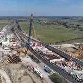 An aerial view of three cranes as the prepare to install bridge beam on the A43 for HS2, March 2025.