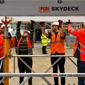 A group of PPE glad people receive formwork training from PERI UK, which delivers hands-on, accredited formwork training at its Brentwood facility and nationwide.