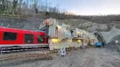 A red railway carriage entering a tunnel