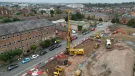 An aerial view of a housing development under construction with a yellow piling rig and other assorted plant.