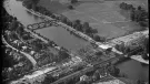 A black and white aerial photo of an under construction bridge