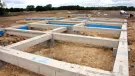 Concrete foundation beams for houses laid out on a construction site